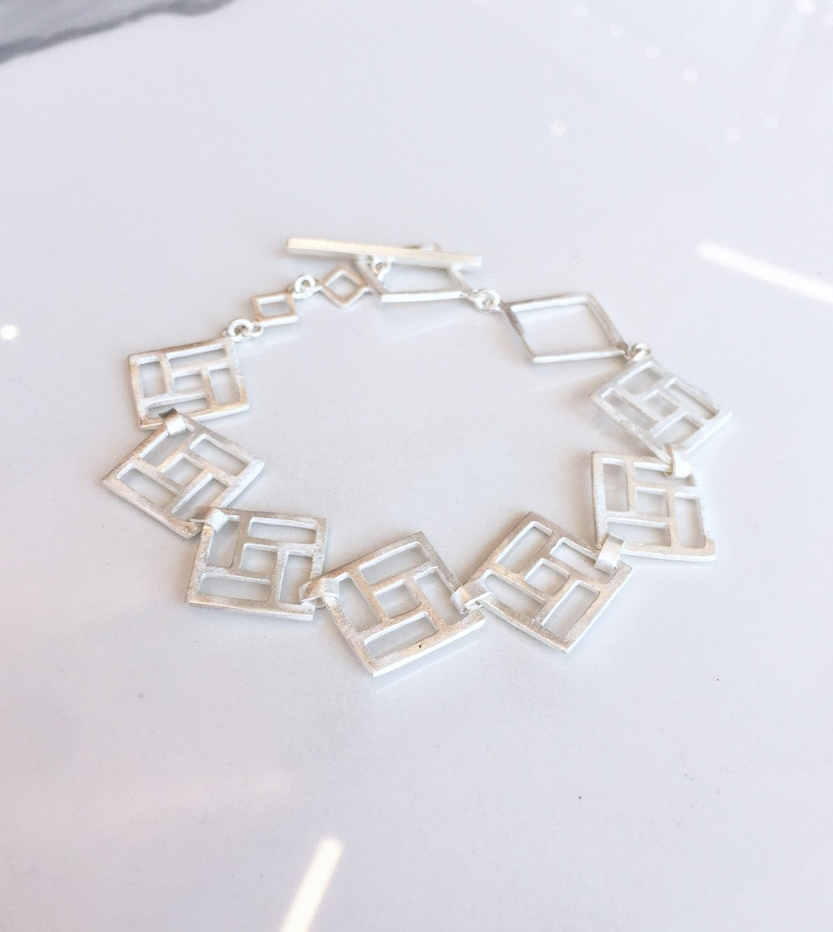 Bracelet à maillons carrés ouverts