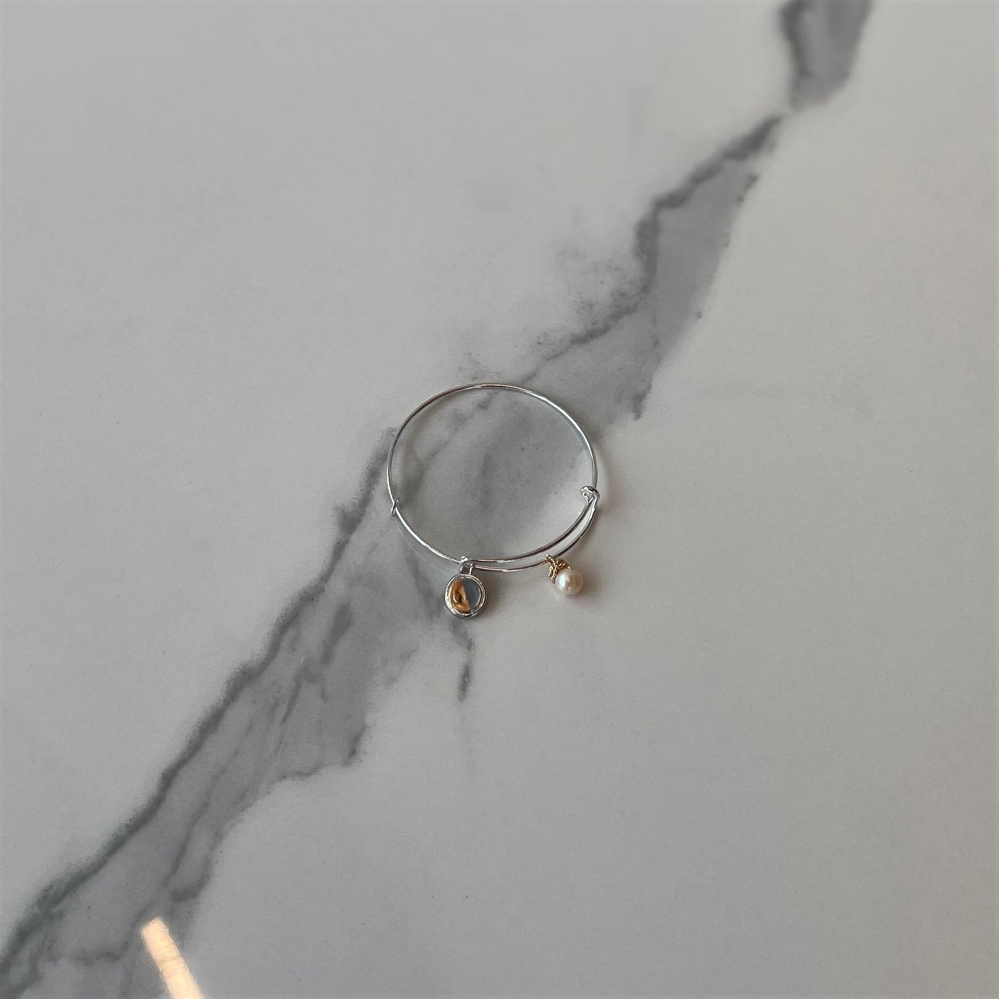 Bangle with pearl and concrete charms